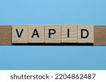 Small photo of word vapid made from wooden gray letters lies on a blue background