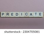 Small photo of gray word predicate made of wooden square letters on brown background