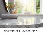 Small photo of Empty marble table top with blurred bathroom interior background