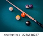 Clean pool table with a few cue ...