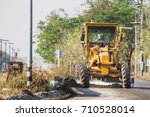 Small photo of Compaction machinery for rail road construction in Chiang Mai, Thailand. Grader is working on a road construction site to smooth the ground.