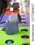Small photo of Side view on a colorful Whack a Mole game at a carnival and arcade, with padded mallets and space for text on top and bottom