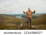 Bearded Man reaching the destination  and on the top of mountain  at sunset on autumn day  Travel  Lifestyle concept The national park Lake District in England