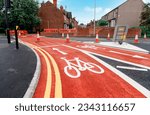 Small photo of New cycling path made of red asphalt as part of 10 minutes city development plan.