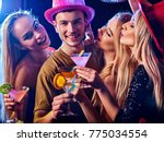 Small photo of Dance party with group people dancing. How to be an alpha male at a club. Women and confident casual smiling man have fun in night club. Seduce boozy woman drink alcohol coktail and cuddles up guy .