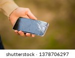 young man hold broken smartphone screen. Broken phone screen in hand