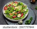 Small photo of Healthy vegetable salad with mussels, mussels, quail, egg, conjugate, lime, spinach, lettuce cherry tomatoes and microgreen. Diet menu Top view.