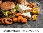 Small photo of Close-up of home made tasty burger and hot dogs with fried chicken french fries. raditional American food. fast food.