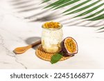 Healthy tropical fruit chia pudding with passionfruit in a glass, Delicious breakfast or snack, Clean eating, dieting, vegan food concept. top view,
