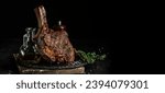 Small photo of Grilled Tomahawk Steak on the bone. Long banner format. copy space for text.