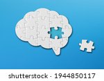 Brain shaped white jigsaw puzzle on blue background, a missing piece of the brain puzzle, mental health and problems with memory	