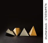 Small photo of Minimal geometry still life composition. Platonic solids figures geometry. Abstract gold and silver color geometrical figures. Three-dimensional pyramid objects on black background.