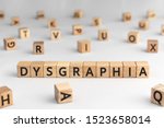 Small photo of Dysgraphia - word from wooden blocks with letters, brain disease or damage, inability to write coherently, Dysgraphia concept, random letters around, white background
