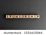 Sponsorship - word from wooden blocks with letters, financially supporting sponsoring fundraising concept,  top view on grey background