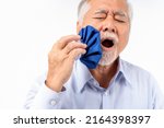 Small photo of asian senior man pain in tooth ache, Mature man feeling pain ,Old elderly male suffering having painful expression toothache, old Man applying ice pack on teeth, Health problems.