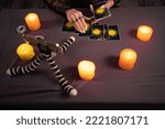 Small photo of Fortune teller reading fortune lines on screen smartphone, online fortune telling application. Palmistry Psychic readings and clairvoyance concept with Tarot cards. Top view
