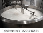 Process of making dairy products in modern dairy factory. Preparing milk for cheese, pasteurization in large tanks. Copy space