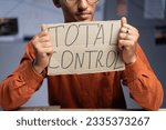 Small photo of Conspiracy and a man sits and holds a inscription - total control in his hands. Conspiracy theorist and fake news. Politics and conspiracy theory. Close-up