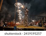 Small photo of Varanasi , India - 8 December 2023, Main famous scene of Aarti of Banaras Ghat priest worshiping with oil lamp and incense sticks at dasaswamedh ghat in Varanasi Uttar Pradesh India