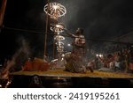 Small photo of Varanasi , India - 8 December 2023, Main famous scene of Aarti of Banaras Ghat priest worshiping with oil lamp and incense sticks at dasaswamedh ghat in Varanasi Uttar Pradesh India