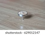 Small photo of Koma (spinning top) Rotating by centrifugal force On Wooden floor.
