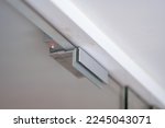 Small photo of An electromagnetic lock, a maglock or electromagnet lock, is a type of locking device that uses an electromagnet to secure a door in place. It is often mounted on glass doors.