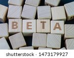 Small photo of Beta coefficient or measure of volatility and risk of an individual stock compare to unsystematic risk in stock market concept, cube wooden block with alphabet combine the word Beta.