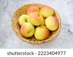 wicker basket with green maiden apples