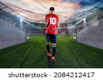 Small photo of Skilled football player with the number ten makes his entrance to the playing field at the stadium