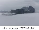View from Mount Hesten in fog from Hesten trail to the Segla mountain on Senja island in northern Norway.