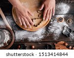 Christmas and New Year celebration traditions. Family home bakery, cooking traditional festive sweets. Woman cutting cookies of raw gingerbread dough