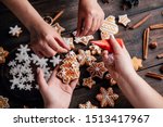 Christmas bakery. Friends decorating freshly baked gingerbread cookies with icing and confectionery mastic. Festive food, family culinary, Christmas and New Year traditions concept