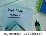 Small photo of Bad Faith Insurance write on a book isolated on office desk. Selective focus on Bad Faith Insurance text