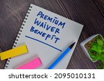 Small photo of Premium Waiver Benefit write on a book isolated on Wooden Table.