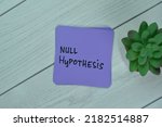 Small photo of Concept of Null Hypothesis write on sticky notes isolated on Wooden Table.
