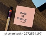 Concept of Sense of Urgency write on sticky notes isolated on Wooden Table.