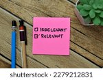 Small photo of Concept of Irrelevant and Relevant write on sticky notes isolated on Wooden Table.