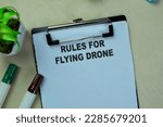 Concept of Rules For Flying Drone write on paperwork isolated on Wooden Table.