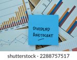 Small photo of Concept of Dividend Aristocrat write on sticky notes isolated on Wooden Table.