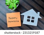 Small photo of Concept of Property Depreciation write on sticky notes isolated on Wooden Table.