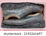 Small photo of Old shoes are kept in shoe storage boxes. The rubber outsole has deteriorated and shattered due to the material deterioration from use and prolonged storage.