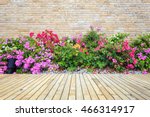 Old hardwood decking or flooring and green plant in garden decorative