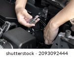 Small photo of A man hold Xenon car headlights and and inserted into the headlight to replace the broken bulb in engine room : Replacing the headlight bulbs of the car itself service concept