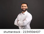 Small photo of Proud Indian male businessman in white smart casual shirt stand with arms crossed isolated on black background, successful hispanic male entrepreneur in confident pose