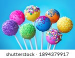 Brightly colored cake pops on a blue background