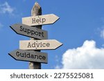 Small photo of Help, support, advice, guidance - wooden signpost with four arrows, sky with clouds