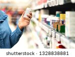 Small photo of Customer in pharmacy holding medicine bottle. Woman reading the label text about medical information or side effects in drug store. Patient shopping pills for migraine or flu. Vitamin or zinc tablets.