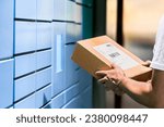 Parcel locker and package delivery service machine. Collect packet at mail storage station at post office. Man holding a box in hand. Blue shipment terminal automat pick up. Courier or customer.