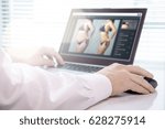 Small photo of Professional photo editor retouching an image of a woman. Transforming girl skinnier and slim with editing software. Focus on mouse hand. Beauty standards, body image and post production concept.