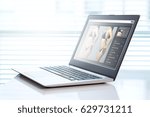 Small photo of Image manipulation software in a laptop in office. Transforming girl skinnier and slim for marketing or advertisement